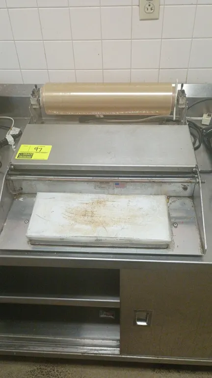 Heat Seal 625A tabletop food wrapping machine. Features stainless steel construction, film roll dispenser, heated seal plate, and cut-off rod. S/N: 20