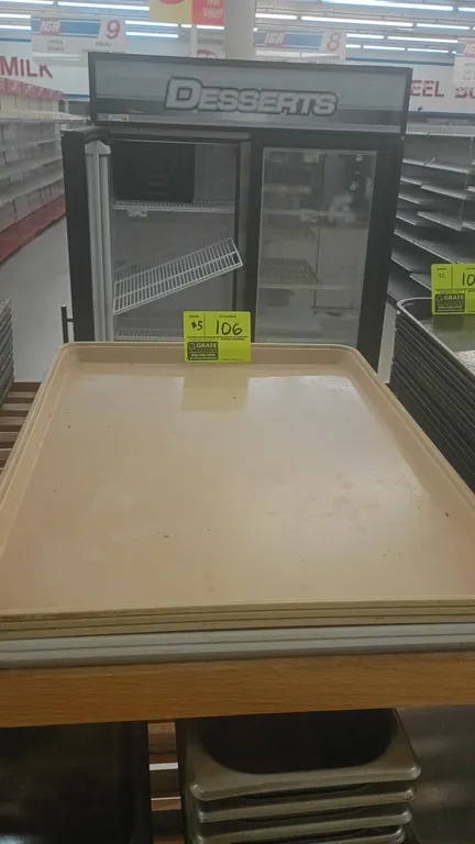 Poly display trays. Features tan polymer construction, raised outer edges, and stackable design.