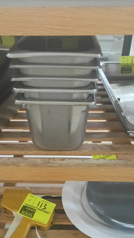 Stainless steel insert pans. Features deep stainless steel construction with rimmed edges and nesting design.