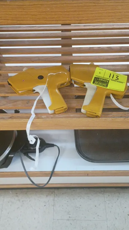 Monarch Marking 1110 handheld price guns. Features yellow molded plastic body with manual squeeze-trigger operation.