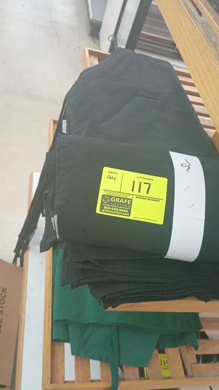 Lot of black fabric aprons. Features waist ties. Shelving and additional items below not included.