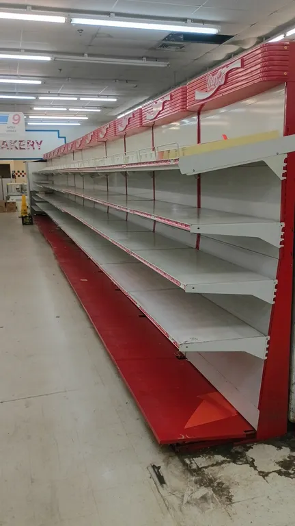 50'L of Coca-Cola branded wall shelving. 91"H uprights with 25"D base shelves. Features Coca-Cola branded canopies, red base shelves, and multi-tier a