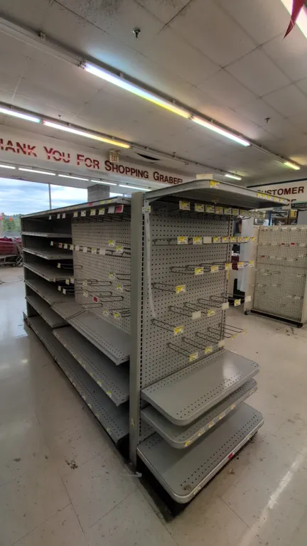 22'L of Madix gondola shelving. 60"H with 16" base shelves. Features gray finish, pegboard backing, metal shelving, display hooks, and (2) 48" sliding
