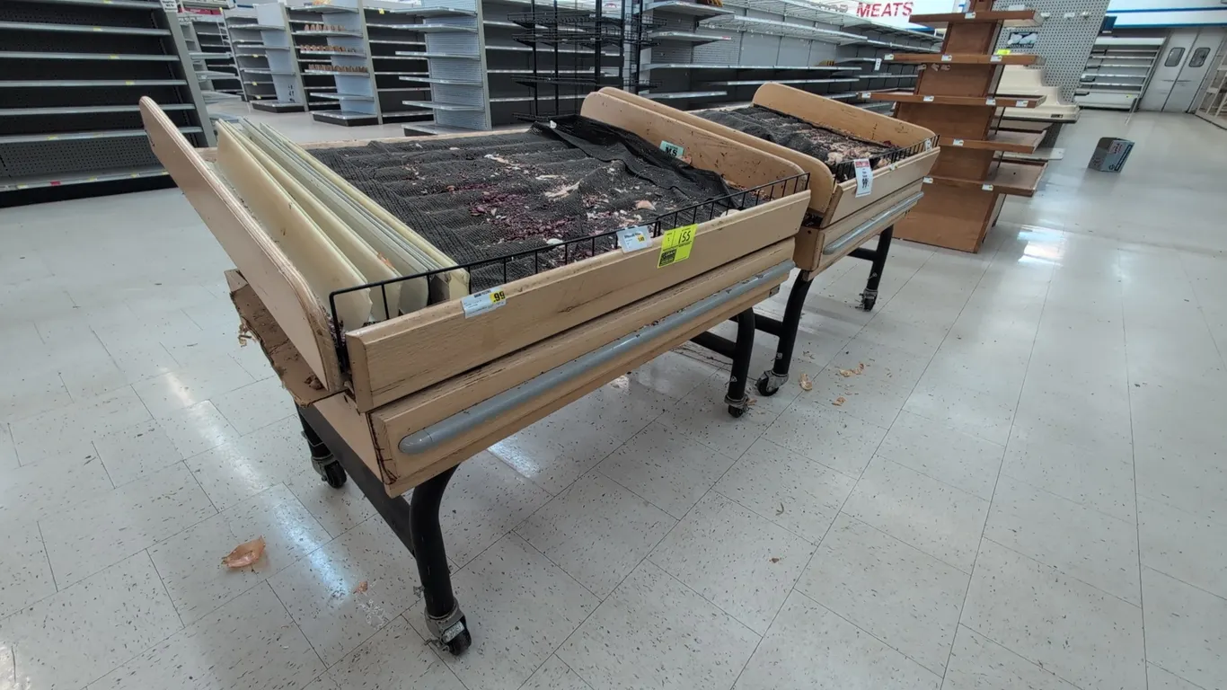 Portable wood euro tilt display tables. Features slatted wood tilt tops, front wire retainers, and protective front bumper rails. 4'L each. Mounted on
