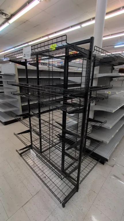 Metal 3-tier merchandise display rack. Features double-sided construction with adjustable wire shelves, front retaining lips, and a black finish. Dime