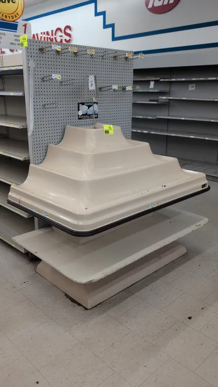 Food Furniture tiered poly produce display table. Features a 3-tier molded polyethylene display surface with black perimeter bumper guard and lower sh