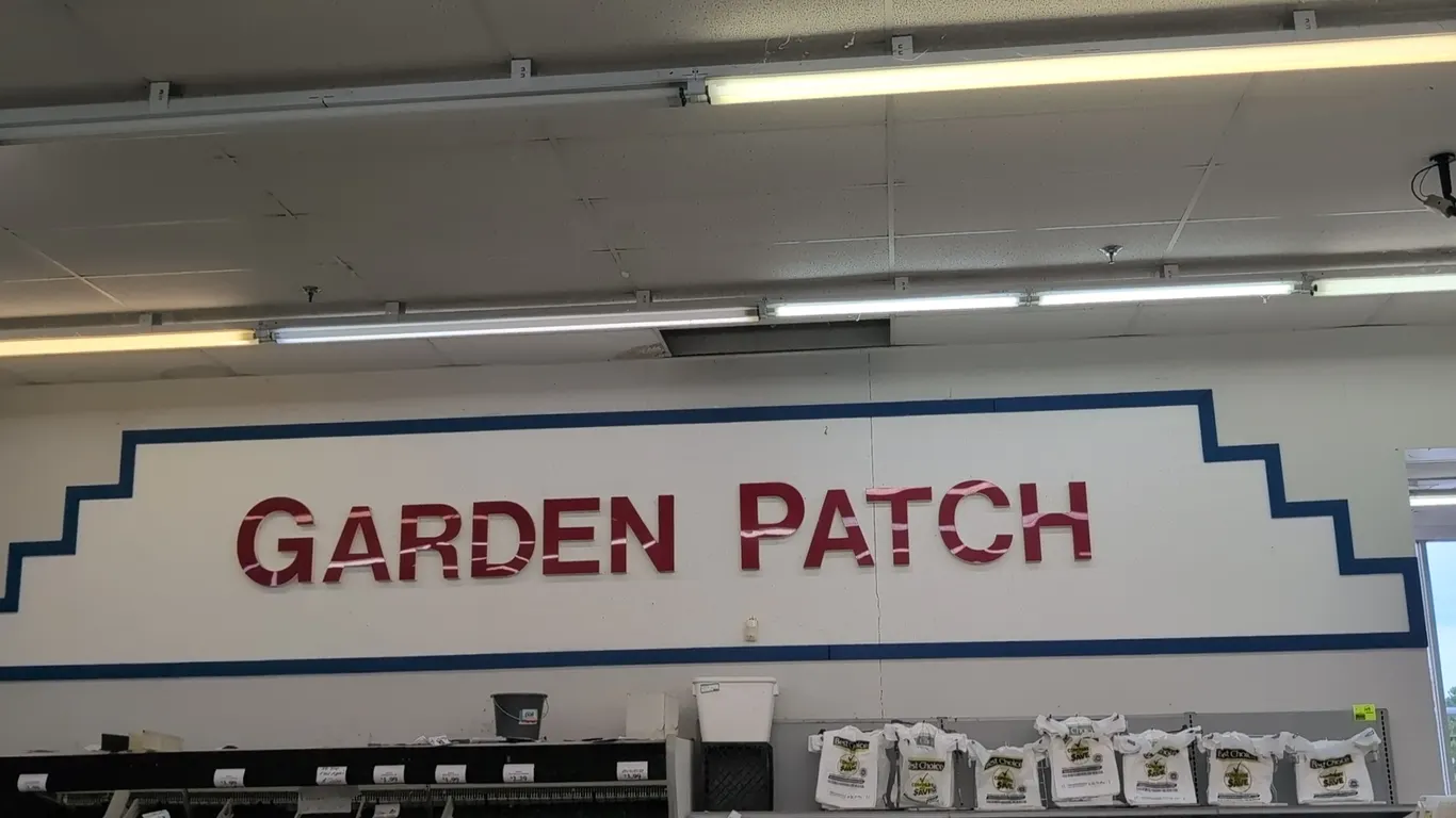 Assorted grocery store signage and decor lot. Includes dimensional wall lettering for store departments ('Produce Market', 'Garden Patch', 'Deli Baker