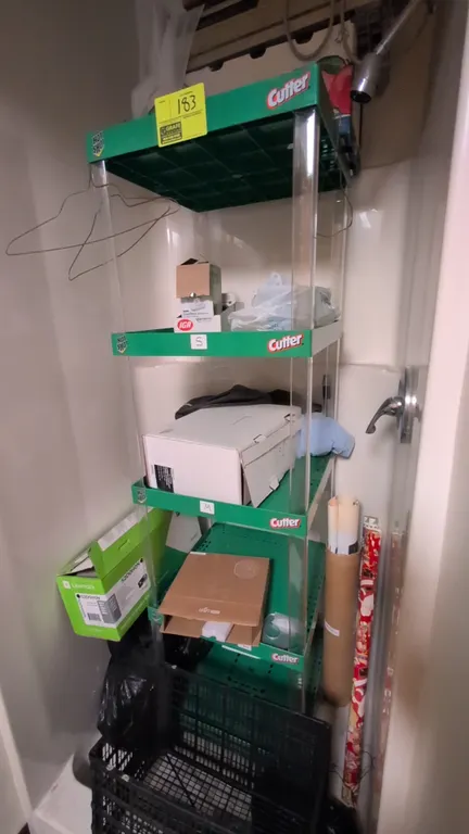 5-tier poly display rack. Features green plastic shelving with clear corner uprights and retail branding. 19"x19"x64". Contents not included.