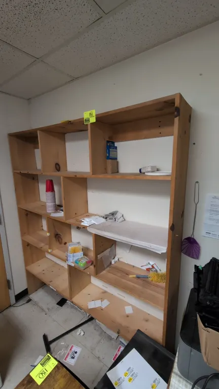 Wood shelving cabinet. Features multi-compartment open shelf design with vertical dividers and open back. Dimensions: 70"W x 11"D x 79"H. Contents not