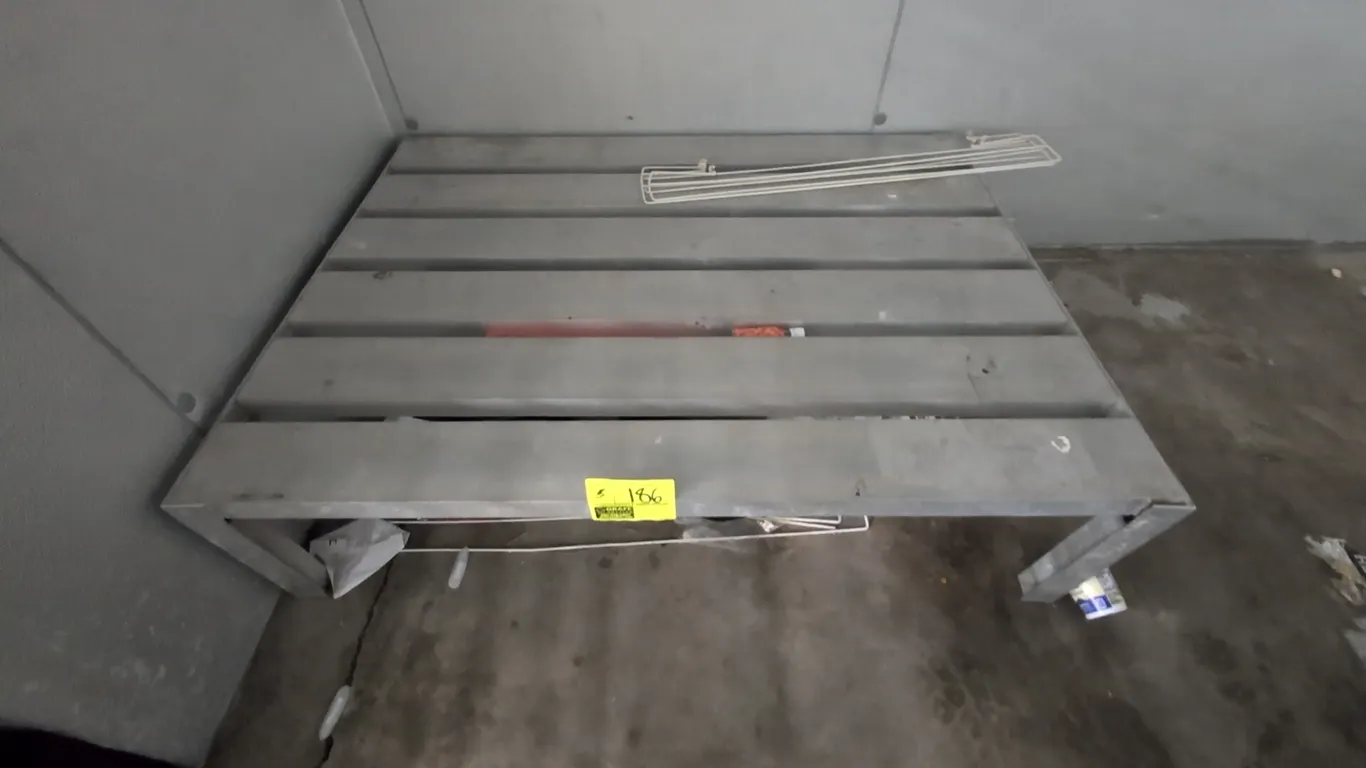 Aluminum dunnage rack. Features welded aluminum construction with a slatted top. Dimensions: 4' x 3'. Contents not included.