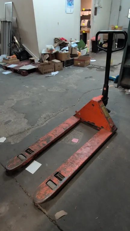 Eagle EAG 27*48 manual hydraulic pallet jack. Features 5,500 lb capacity, looped control handle with release lever, polyurethane steer wheels, and ent