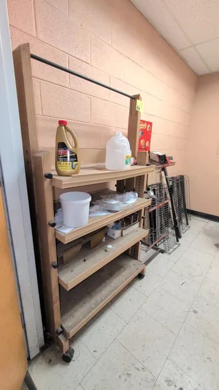 Quantity of assorted retail display racks. Includes rolling multi-tier wooden display cart, Popcornopolis snack display stand, wire publication racks,