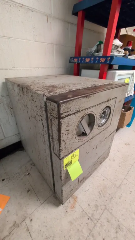 Fire-resistant metal safe. Features a mechanical combination dial lock, recessed turn handle, and one interior shelf. UL Class 350 2-hour fire enduran