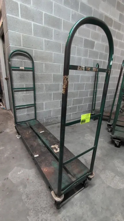 Metal U-boat cart. Features dual tall tubular steel handles, steel deck, and protective corner bumpers. Mounted on rigid center wheels with swivel end