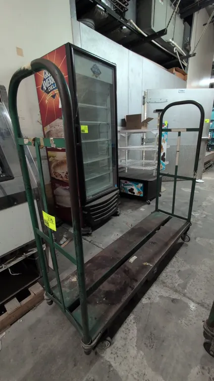 Metal U-boat cart. Features dual tubular steel end handles and a steel platform bed. 5'L. Mounted on a 6-wheel center-tilt caster configuration.