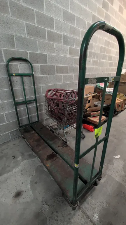 Metal U-boat stock cart. Features dual tubular steel end handles and a solid steel platform deck. 5'L. Mounted on 6 casters with center-tilt design. S