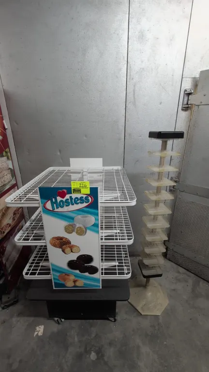 Merchandise display racks. Includes (1) 36"x32"x54" portable poly and metal merchandise rack with 3-tier wire shelving, Hostess graphics, mounted on c