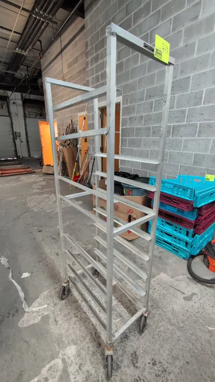 Aluminum mobile meat lug rack. Features angle slide runners and welded aluminum frame construction. Dimensions: 15" x 69"H. Mounted on swivel casters.