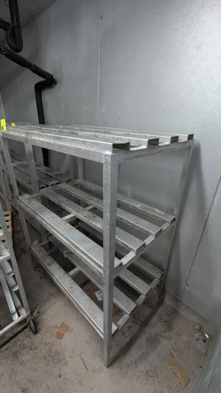 Aluminum dunnage racks. Features welded tubular aluminum frame construction and slatted shelving tiers. Dimensions: 48"W x 30"D x 60"H. Contents not i