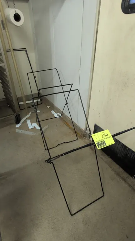 Metal X-frame collapsible stands. Features black coated wire construction and folding design for flat storage. Dimensions: 31"H.