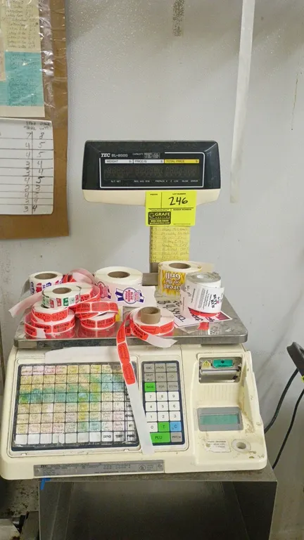 TEC SL-9000 digital price computing scale. Features pole-mounted digital display, stainless steel weigh platter, preset programmable keypad, and integ