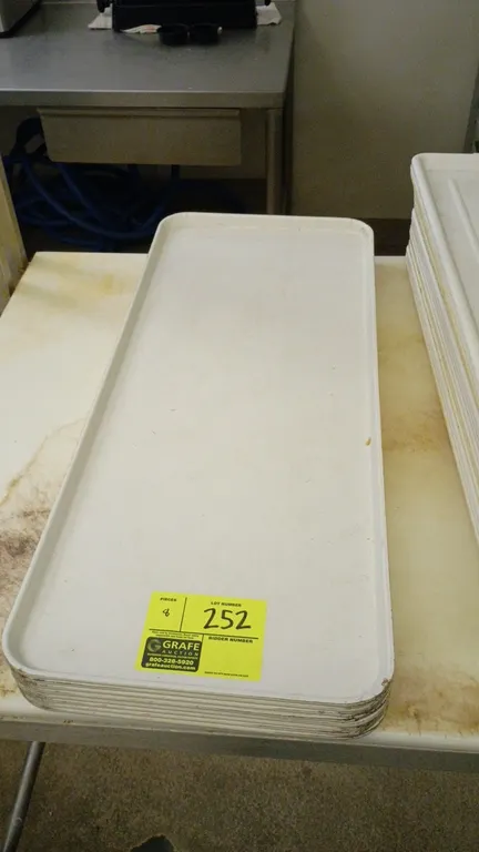 Poly meat display trays. Features white molded polymer construction with raised edges and stackable design.