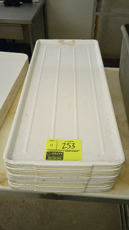 Poly meat display trays. Features molded white plastic construction with ribbed bases and raised perimeter rims.