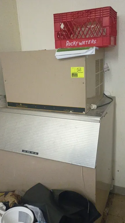 Manitowoc 400 Series ice maker with storage bin. Features top-mounted ice machine head unit, air-cooled side louvers, front-opening bin access door, a