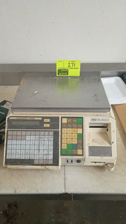 TEC SL-5900 price computing scale. Features stainless steel weighing platter, membrane keypad, integrated label printer, and detached customer pole di