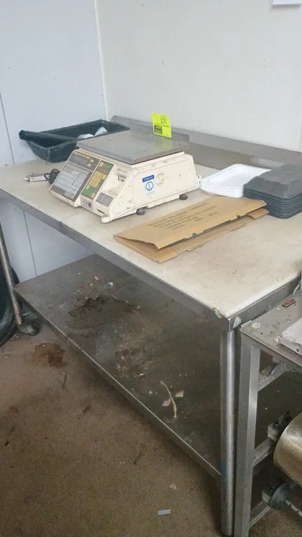 Stainless steel prep table. Features a poly prep surface, rear backsplash, and lower stainless steel undershelf. Supported by tubular legs. 60"x30"x40