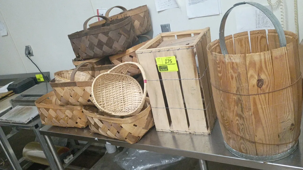 Assorted collection of display and produce containers. Includes woven wood splint market baskets with handles, woven wicker baskets, a wirebound woode
