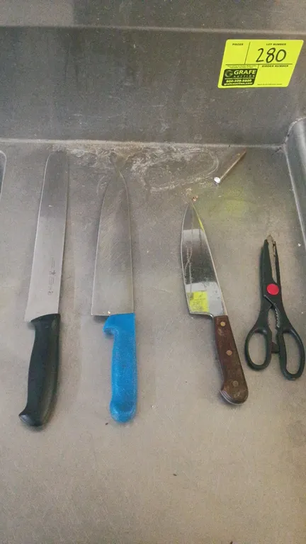 Assorted kitchen cutlery and utensil lot. Includes a wall-mounted stainless steel knife rack, (3) kitchen knives including J.A. Henckels, kitchen shea