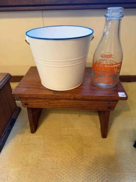 small wood seat, small metal milk bucket,