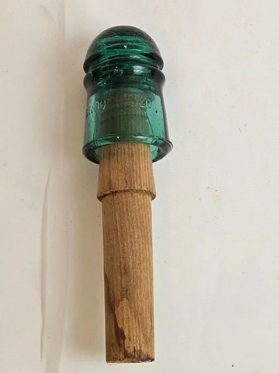 Green Glass Insulator on Wooden Handle