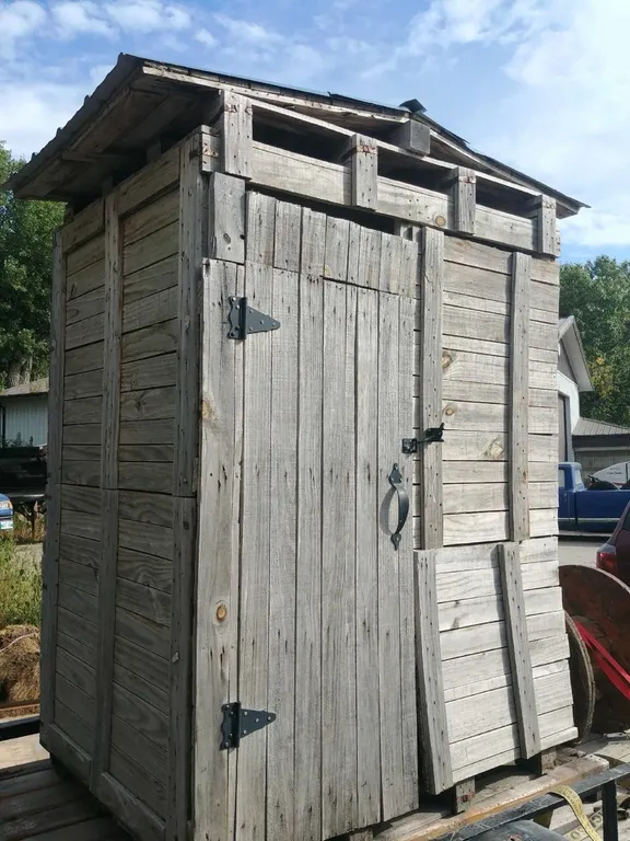 OFFSITE - Small garden shed, tin roof. Painted inside, with hooks and labels for garden tools. Some pots and a metal shelf included