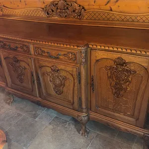 Carved Oak Sideboard with Ornate Detailing and Brass Handles