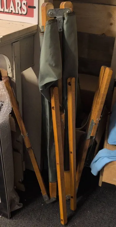 Military Cot, Blue Sweater, Pants, Military Cap and Assorted Hangers