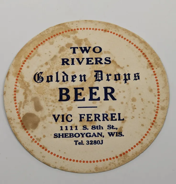 TWO RIVERS GOLDEN DROPS BEER COASTER VIC FERREL SHEBOYGAN WISCONSIN