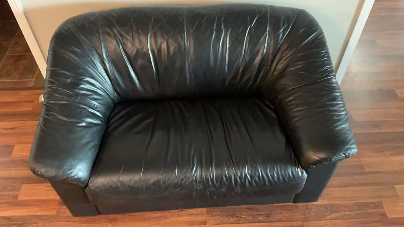2 Black Leather Couches and a Storage Ottoman