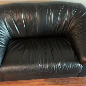 2 Black Leather Couches and a Storage Ottoman