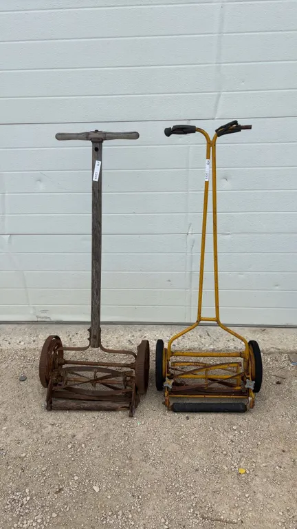 Two Push Reel Mowers: One Yellow Metal, One Wood and Metal