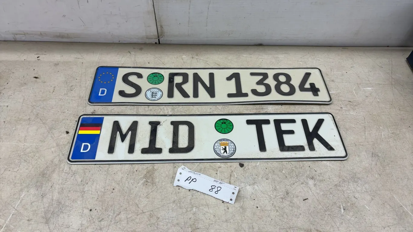 Pair of German-Style Novelty License Plates, "SÖRN 1384” and "MID TEK" with EU and TÜV Seals