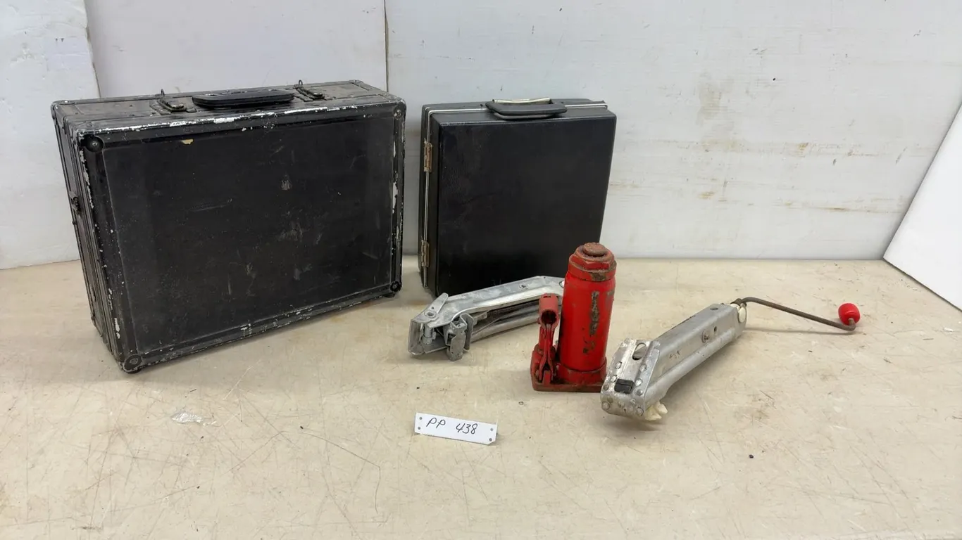 Two Cases, Red Hydraulic Jack, and Two Metal Hand Tools