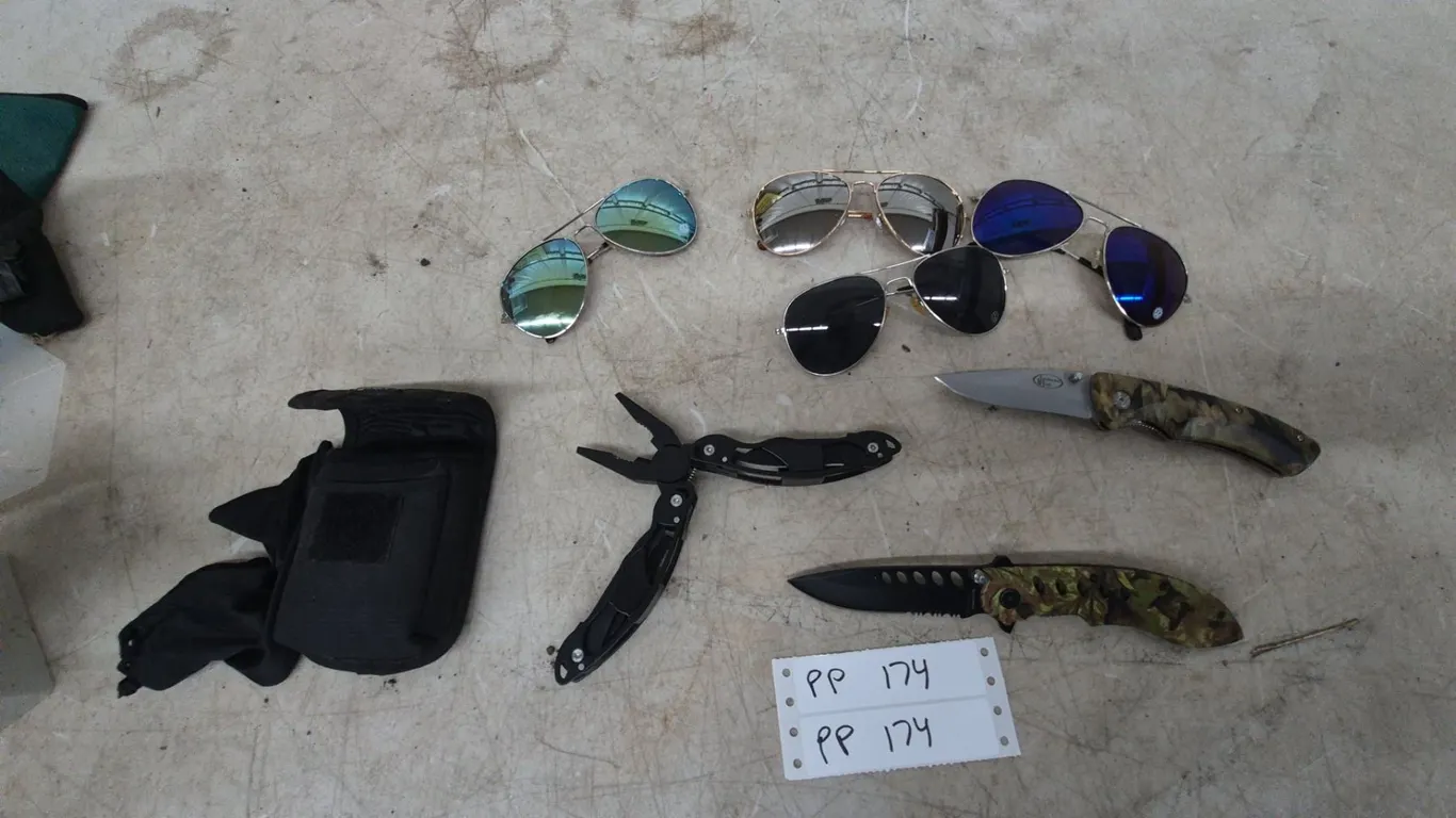 Two Camouflage Folding Knives, Multi-Tool Pliers, and Four Pairs of vw Sunglasses