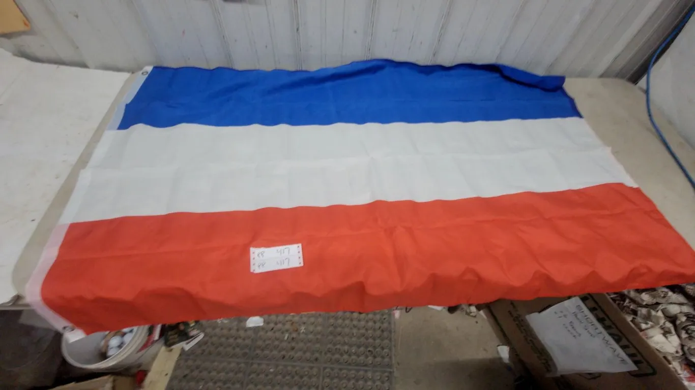 Flags and Warning Sign: Union Jack Flag, Blue White Red Flag, and "Nothing Worth Dying For" Sign
