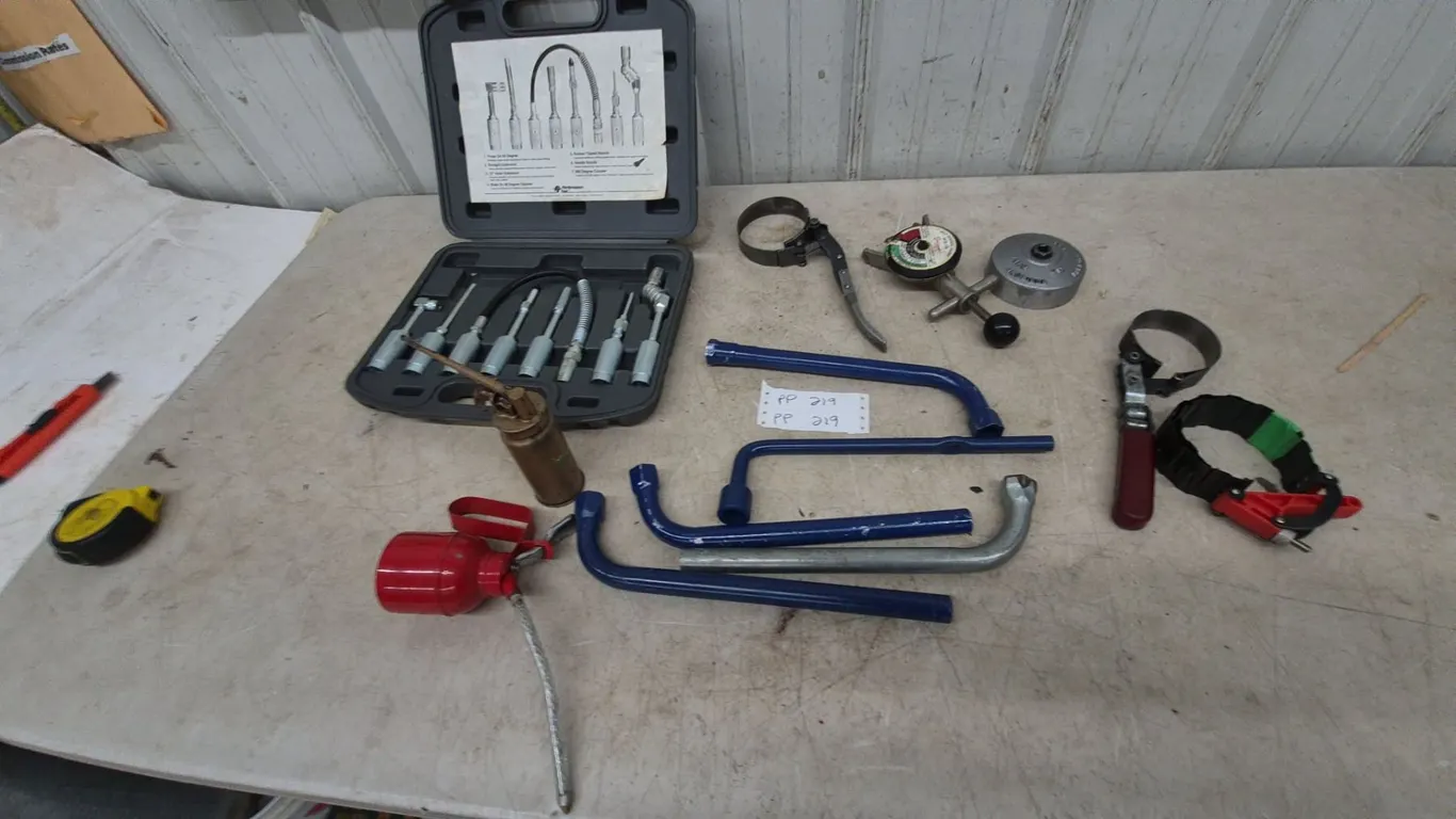 Assorted Automotive Tools: Performance Tool Grease Gun Set, Oil Cans, and Lug Wrenches belt