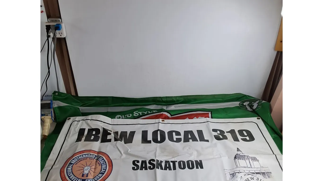 (2) Banners - 34" x 58" Saskatchewan Roughriders "Pilsner", 47" x 24" IBEW Local 319