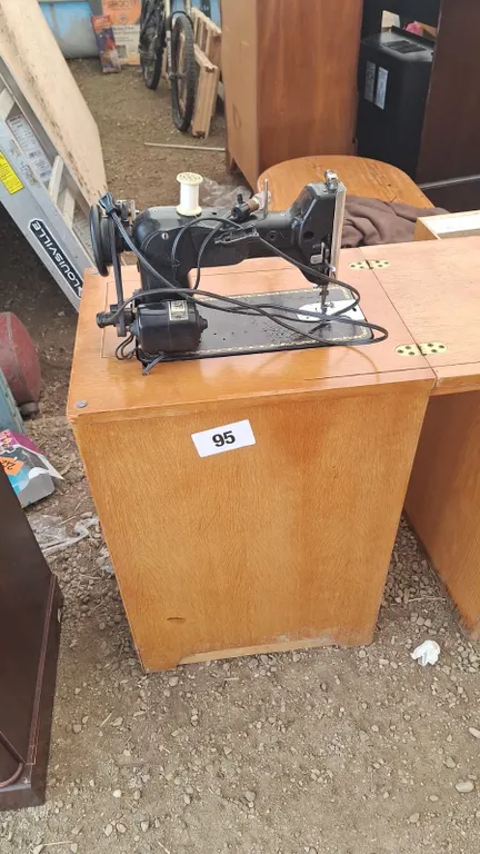 Antique sewing machine with desk and contents