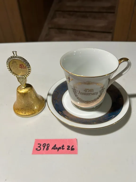 40th Anniversary metal bell and 45th Anniversary teacup and saucer set