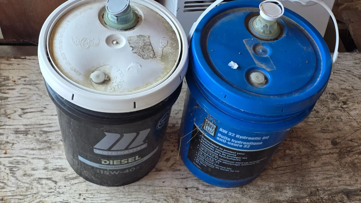 Bucket of 15w40 oil - 3/4 full and bucket of hydraulic oil- 1/4 full